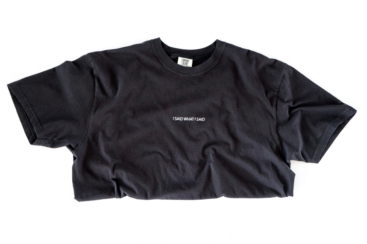 Black t-shirt with white text on a white background saying I said what I said