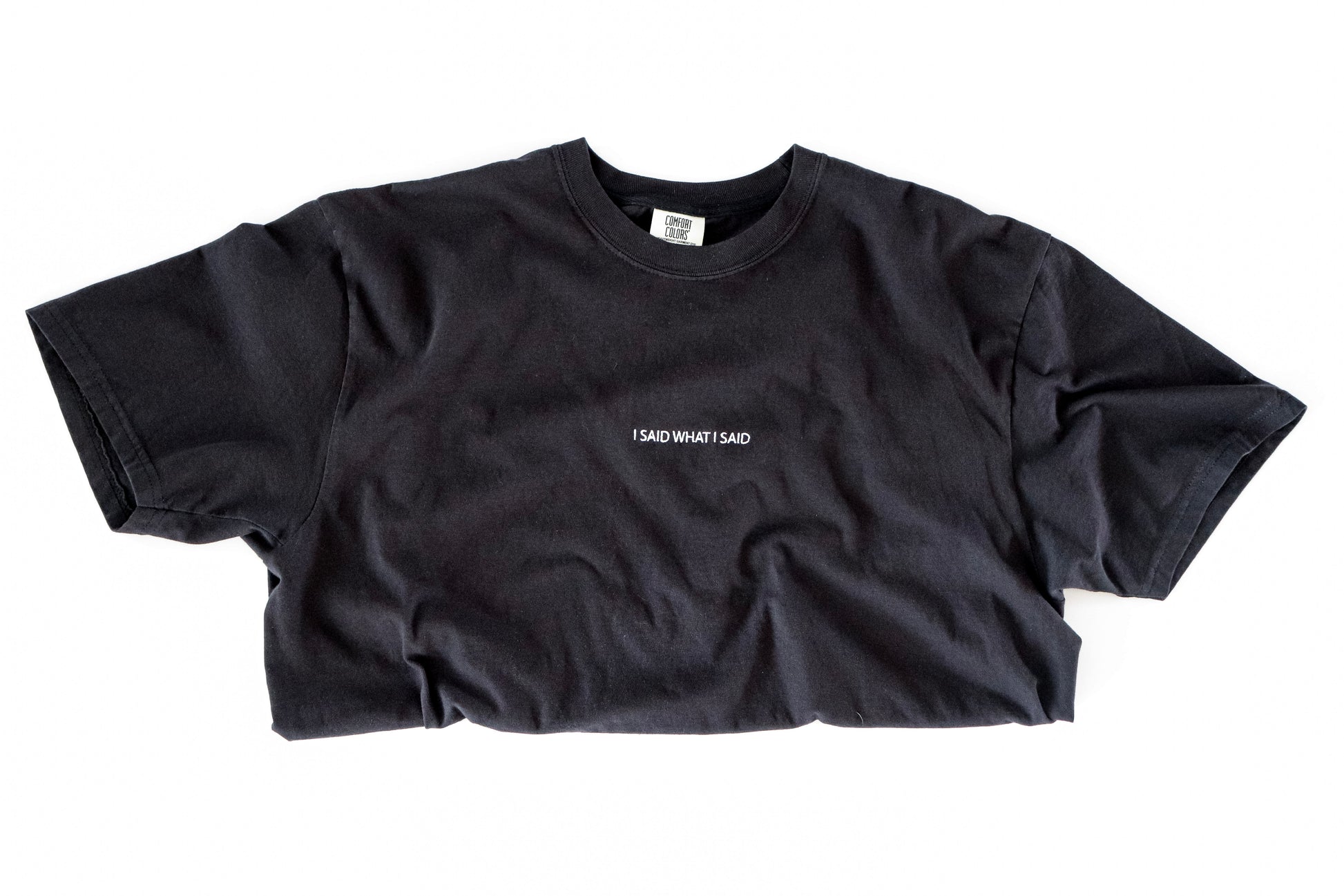 Black t-shirt with white text on a white background saying I said what I said