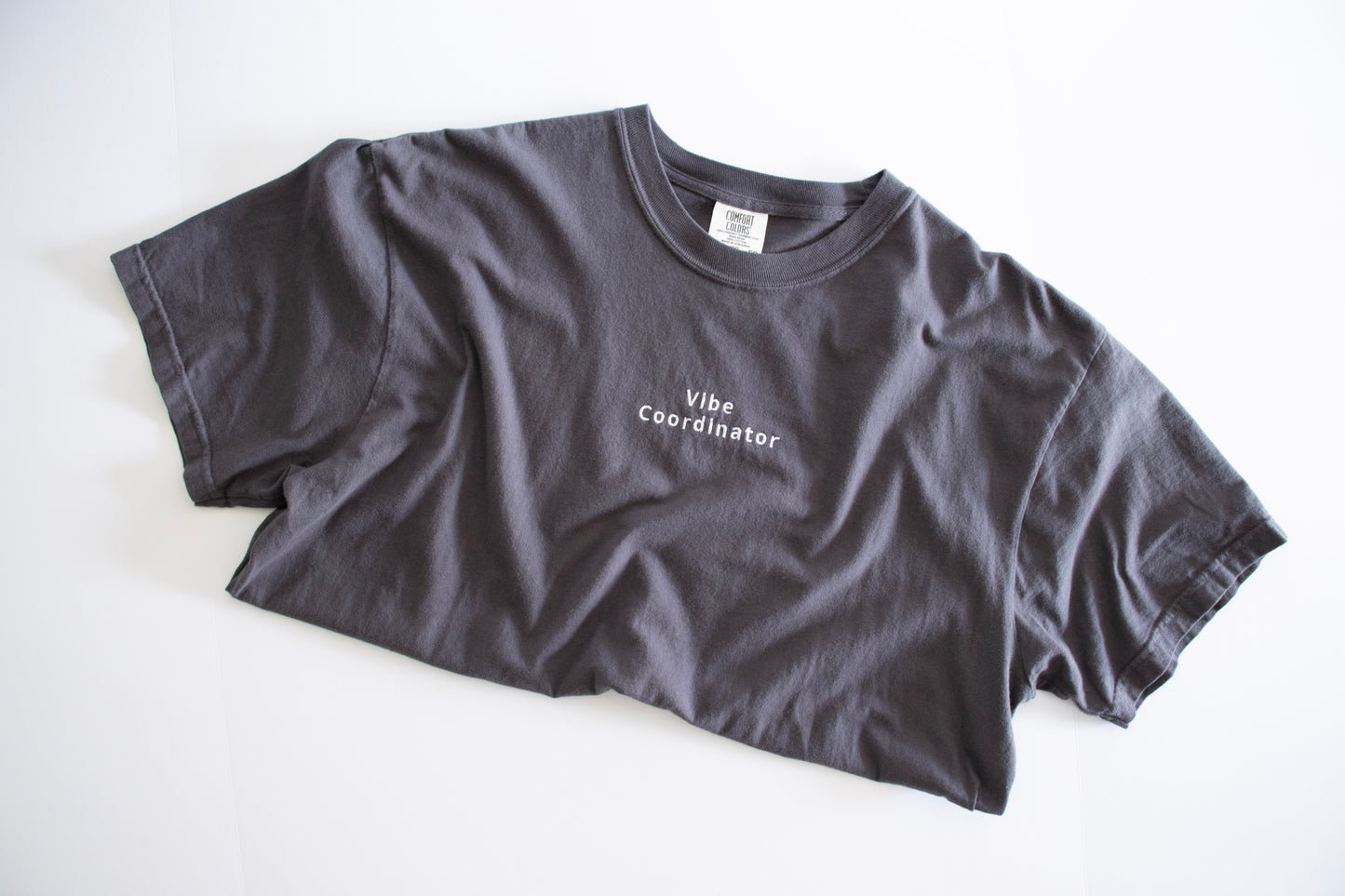 Gray t-shirt with 'Vibe Coordinator' text on a white background